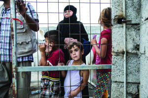 Young displaced Iraqis wait for food distribution at a camp on the outskirts of Erbil. *MUST CREDIT* Mackenzie Knowles-Coursin for the United States Holocaust Memorial Museum (2015)